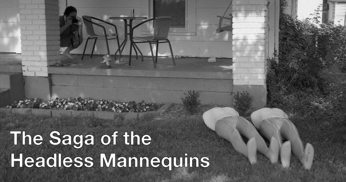 Summary graphic: A black and white photo of a man crounching down on a front porch and taking a photo of two headless mannequin bodies laid out on the lawn.