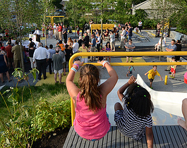 Summary graphic: Children play atop a slide while a multitide of adults mingle in a brand new tree-filled park.