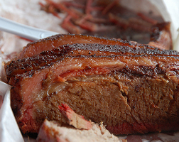 Summary graphic: Sliced brisket upon a simple tray. The food is way better than this photo shows.