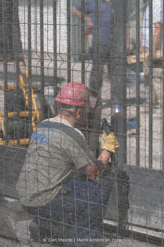A construction worker welds a gate outside the Basilica de la Sagrada Familia.