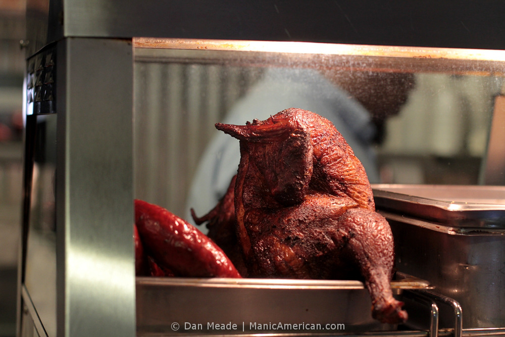 Belinda's assistant behind a display chicken.