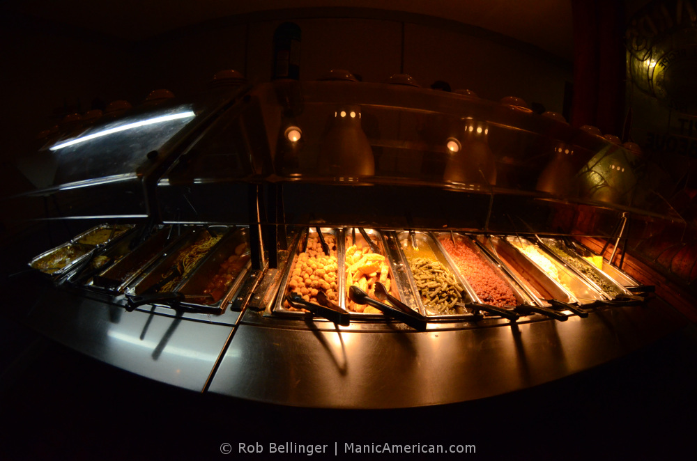 A wide-angle view of side dishes in a buffet steam table