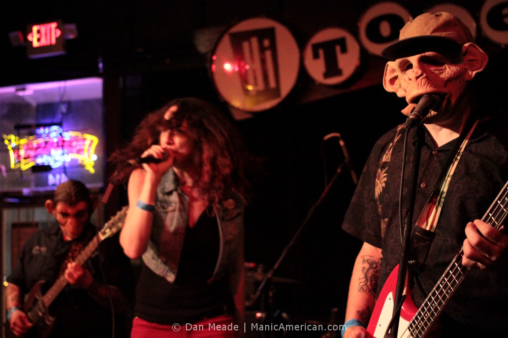 a band performing in ape masks