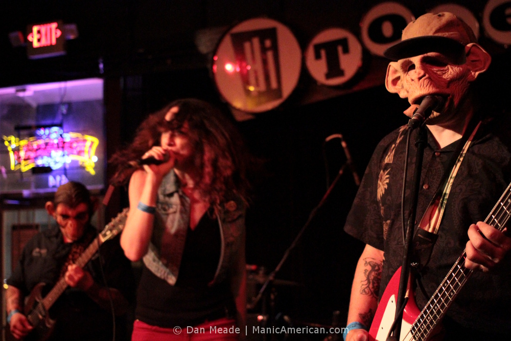 a band performing in ape masks