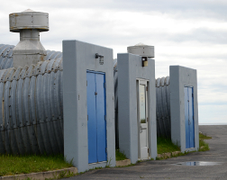 Three doors at the end of corrugated steel tubes in the middle of nowhere.