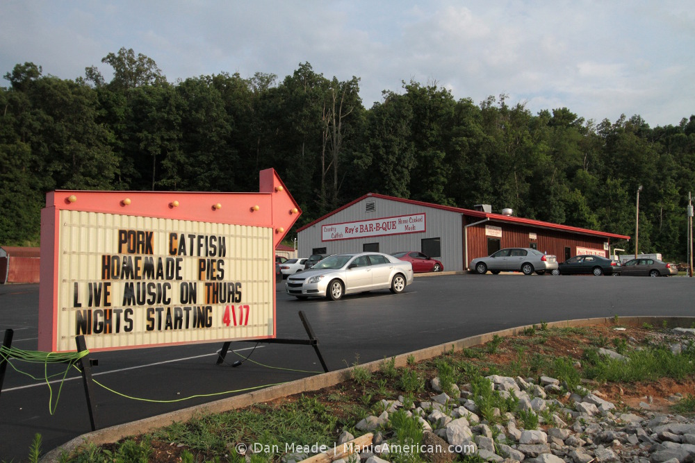 A roadside sign points the way to Roy's Kentucky barbecue.