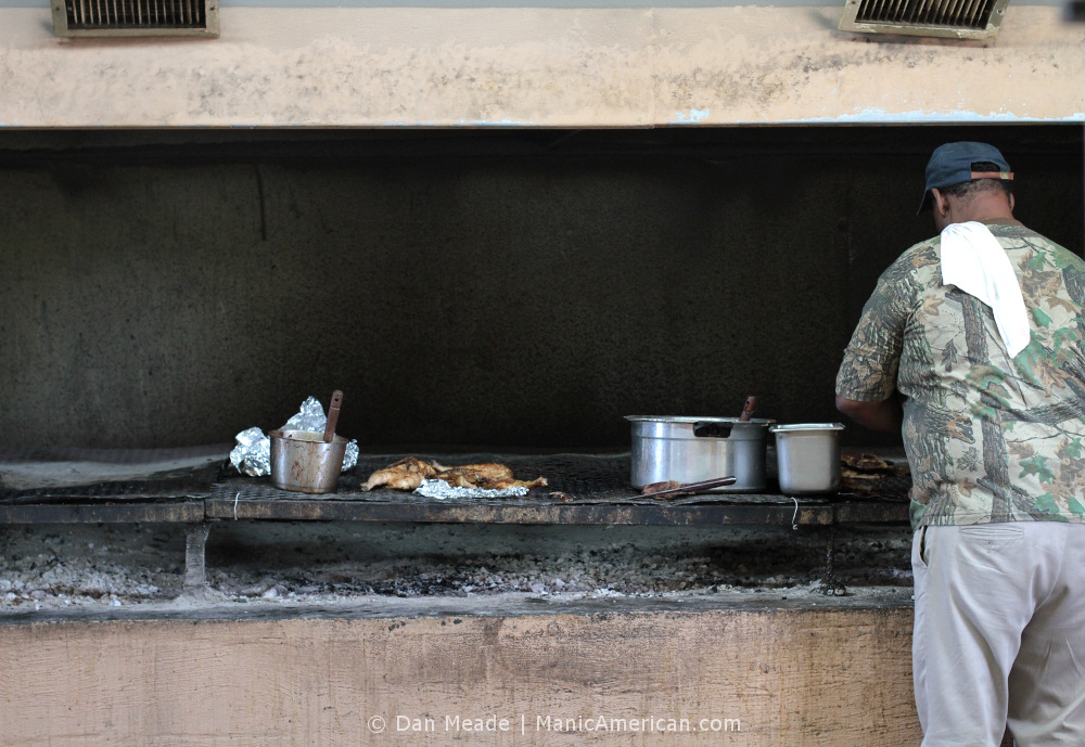 A worker tends the grill at R&S BBQ, a Kentucky barbecue restaurant.