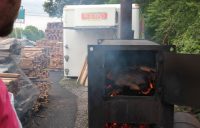 Making Kentucky barbecue: The coalmaster watches as wood burns down to coals.