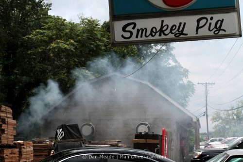 An employee takes a break behind a cloud of smoke outside the Smokey Pig, a Kentucky barbecue restaurant.