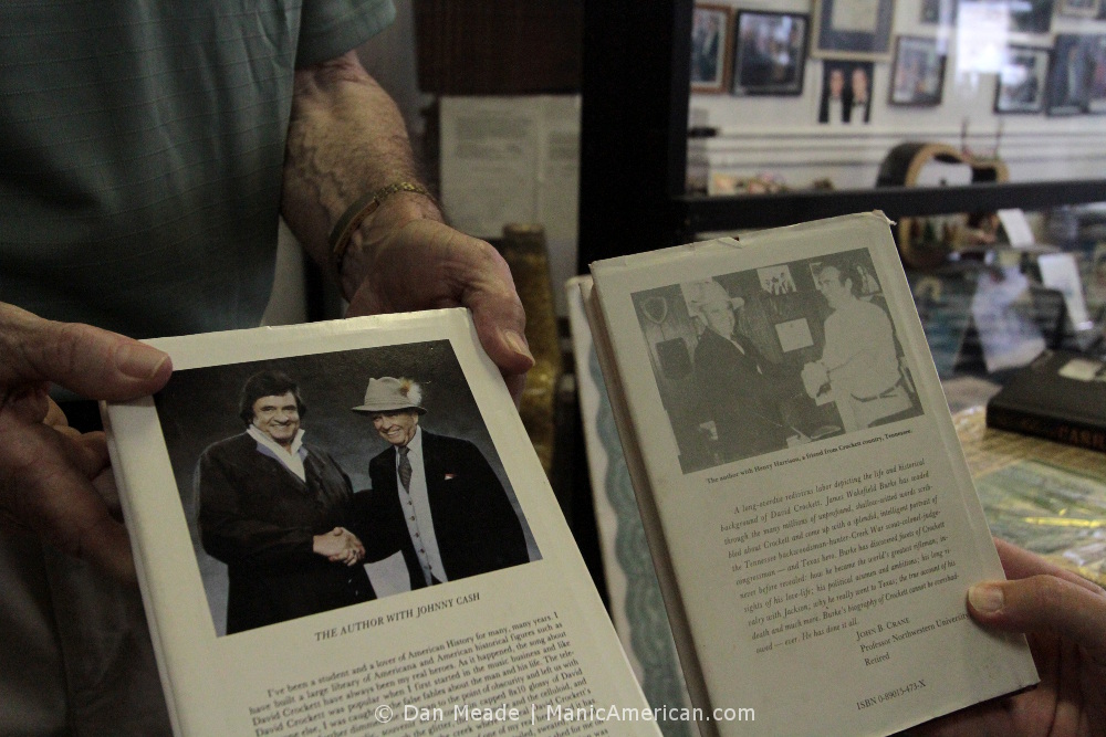 Henry Harrison hands out books for viewing.