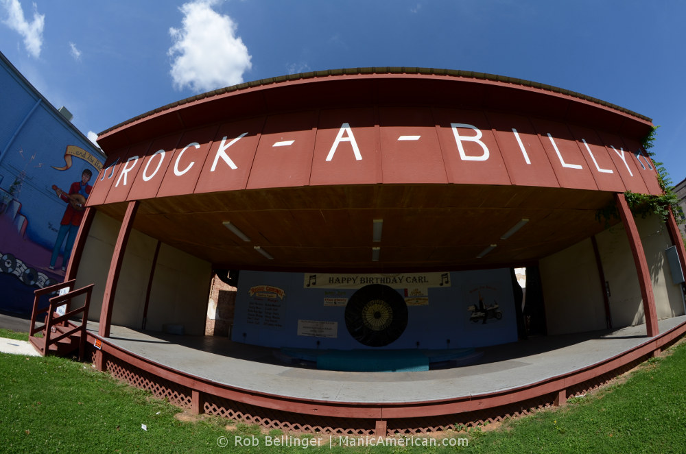 An exterior stage with the words ROCK-A-BILLY painted on the wooden awning above