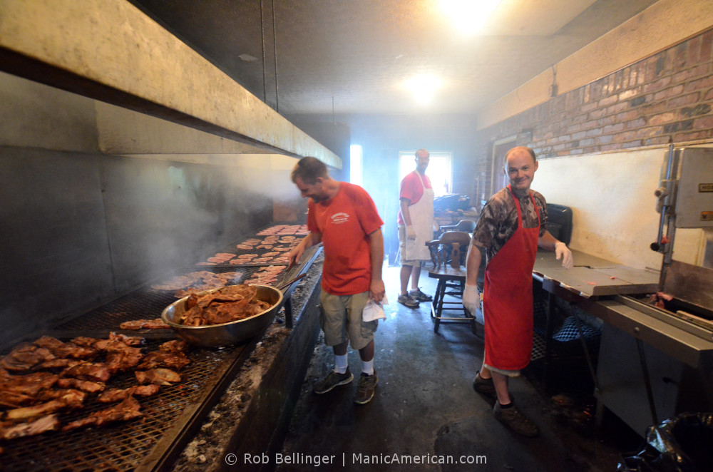 Three men work in the cookhouse of the Smokey Pig Kentucky barbecue restaurant.