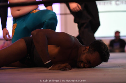 A wrestler lands on the mat face-first
