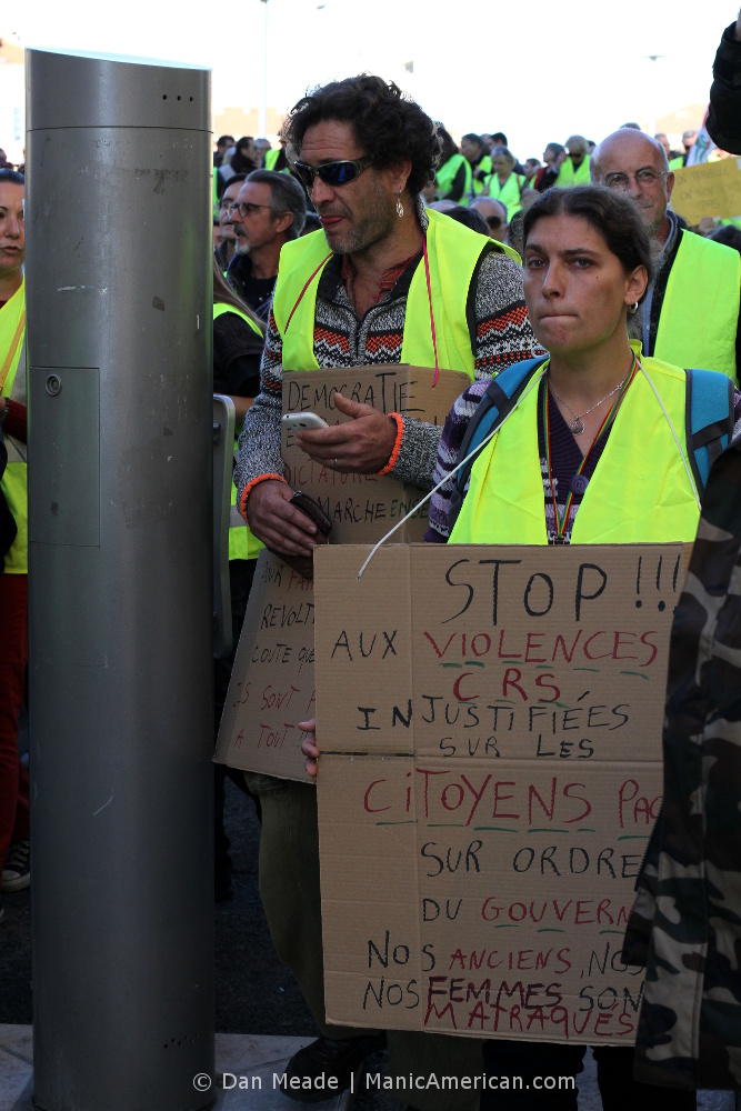 Placard wearing gilets jaunes protestors.