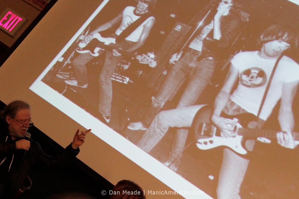 Tommy Ramone points to a photo of the band.