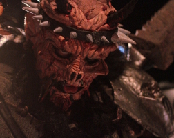 A close-up photo of GWAR’s David Brockie as David Brockie as Oderus Urungus. Brockie looks through his Oderus mask directly at the camera.