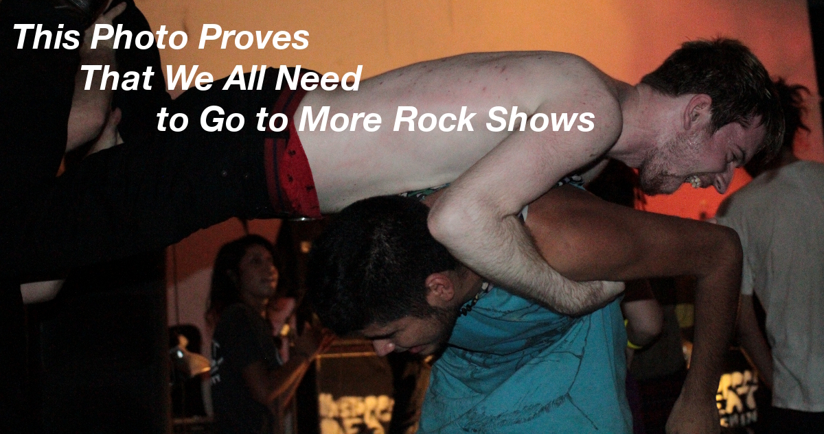 Summary graphic: Two men in a small rock club, both shirtless. One lays atop the other’s back and the both spin around in a circle, smiling, and enjoying the show.