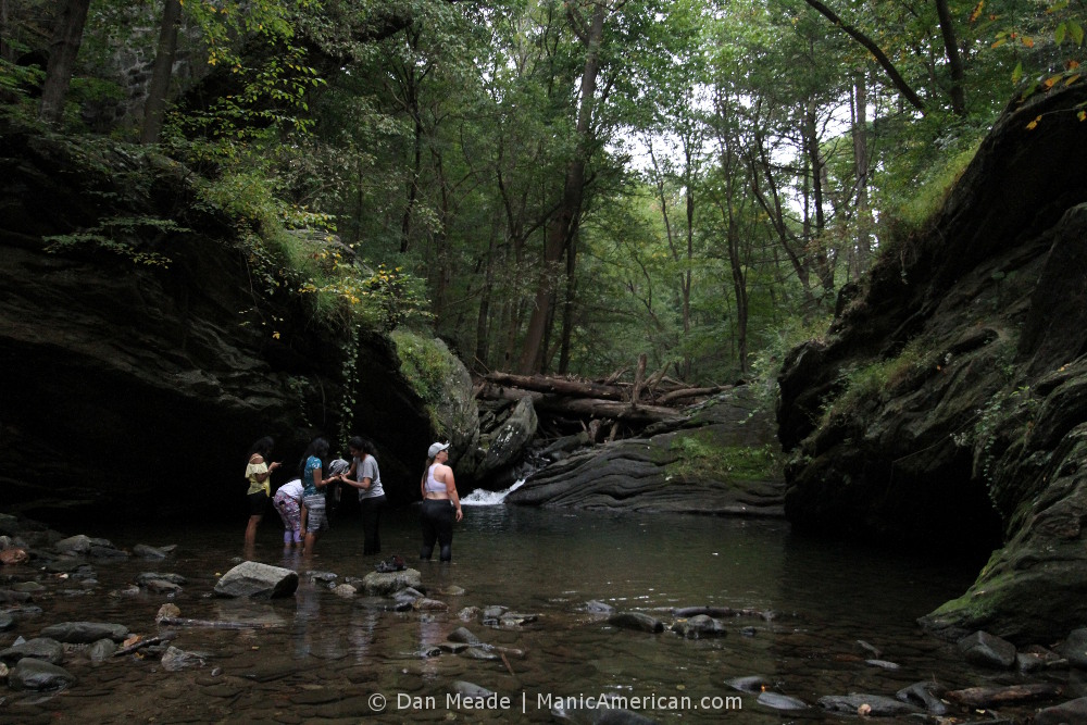 five women stand calf-deep in the Devil's Pool