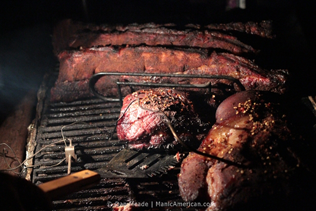A late-night check on the progress within a smoker.