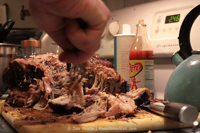 A pork butt being pulled.