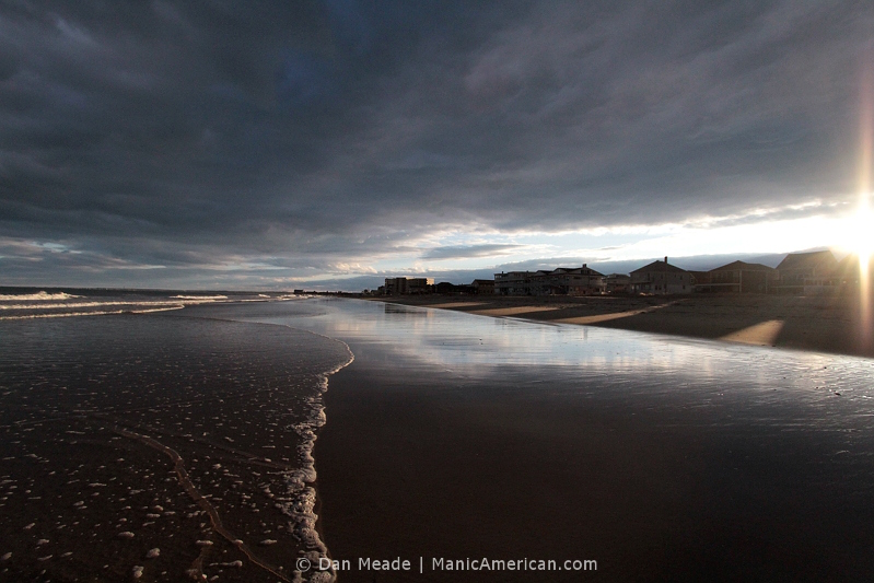 A cloudy sky reflected over the shore of Old Orchard Beach.