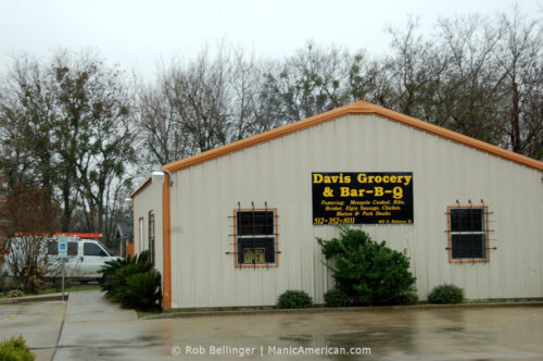 A small building of corrugated steel with a sign that reads Davis Grocery & Bar-B-Q