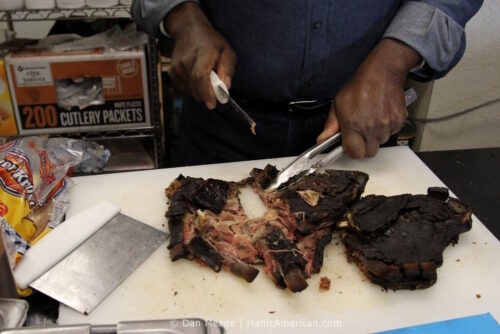 Rev. Davis carves mutton ribs.