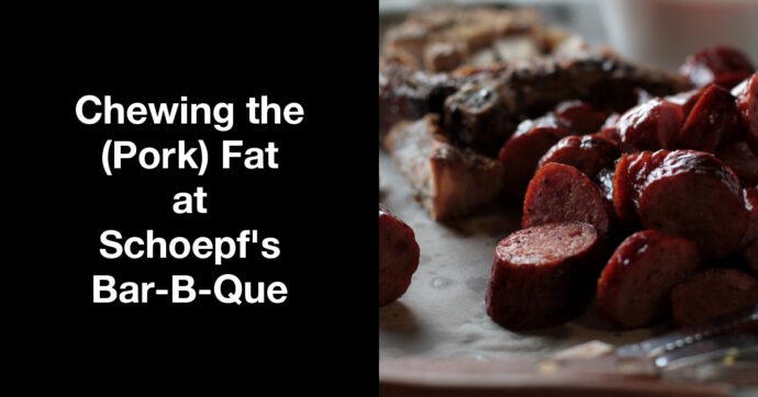 Summary graphic: A pile of sliced sausage links with a pork chop in the background.