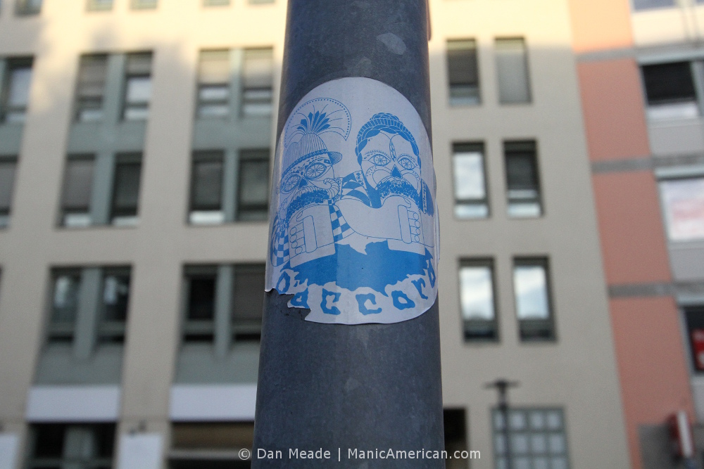 A sticker by D'ACCORD showing a candy skull Oktoberfest couple.