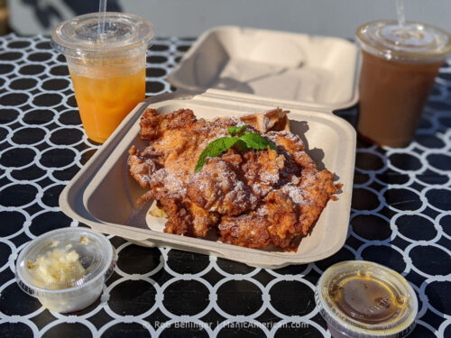 slices of fried chicken over waffles with cups of iced coffee and honey butter at bernadette's in rockaway beach