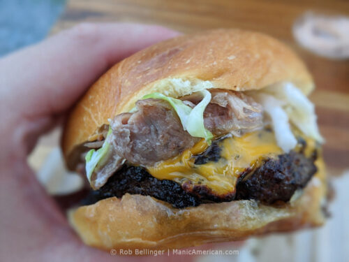 a hamburger topped with chunks of smoked pork at RBQ in rockaway beach