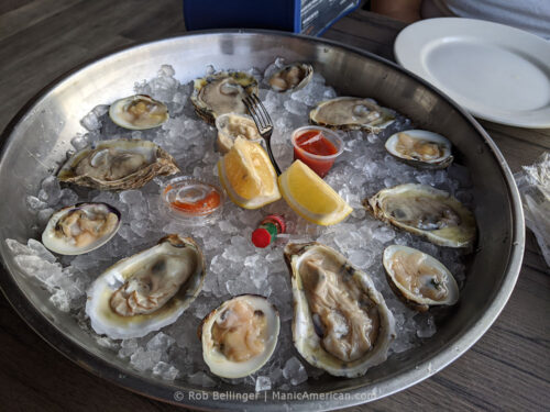 shucked oysters and clams on a plate of ice at bungalow bar in rockaway beach